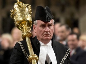 In a Thursday, Oct.  23, 2014 file photo, Sergeant-at-Arms Kevin Vickers receives a standing ovation as he enters the House of Commons in Ottawa.