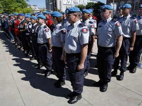 A contingent of police officers training to deploy to Haiti for a year stand at attention at the National Peacekeeping Monument on National Peacekeepers' Day in Ottawa on Sunday, Aug. 11, 2013.