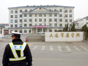 A police officer stands outside a prison in Dalian in China's Liaoning Province.
