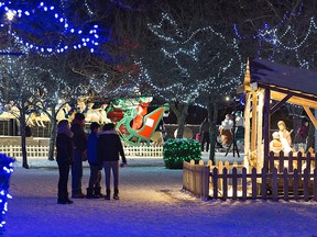 People pause to look at a nativity scene at the 60th annual Christmas Panorama at Wellington Park in Simcoe, Ont., on Dec. 8, 2018.