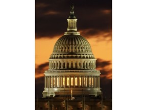 The U.S. Capitol dome is seen just before sunrise in Washington, Saturday, Dec. 22, 2018. Hundreds of thousands of federal workers faced a partial government shutdown early Saturday after Democrats refused to meet President Donald Trump's demands for $5 billion to start erecting a border wall with Mexico.
