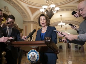 House Democratic Leader Nancy Pelosi of California, the speaker-designate for the new Congress in January, talks to reporters after meeting with Senate Minority Leader Chuck Schumer, D-N.Y., as Congress and President Donald Trump bicker over his demand that lawmakers fund a wall along the U.S.-Mexico border, pushing the government to the brink of a partial shutdown, in Washington, Tuesday, Dec. 18, 2018. Without a resolution, parts of the federal government will shut down at midnight Friday.