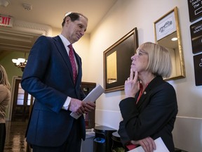 Sen. Ron Wyden, D-Ore., left, and Sen. Patty Murray, D-Ore., wait for Sen. Joe Manchin, D-W.Va., before a news conference to press Congress to intervene on behalf of the Affordable Care Act, after a federal judge in Texas ruled it unconstitutional, on Capitol Hill in Washington, Wednesday, Dec. 19, 2018.