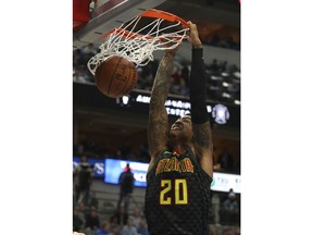Atlanta Hawks forward John Collins (20) dunks the ball against the Dallas Mavericks in the first half of an NBA basketball game Wednesday, Dec. 12 2018, in Dallas.