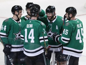 Dallas Stars left wing Jamie Benn (14) celebrates scoring a goal with teammates Gavin Bayreuther (44), Alexander Radulov (47), Tyler Seguin (91) and Roman Polak (45) during the first period of an NHL hockey game against the Calgary Flames in Dallas, Tuesday, Dec. 18, 2018.