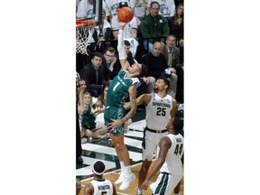 Green Bay's Sandy Cohen III (1) puts up a layup against Michigan State's Kenny Goins (25) during the first half of an NCAA college basketball game, Sunday, Dec. 16, 2018, in East Lansing, Mich.