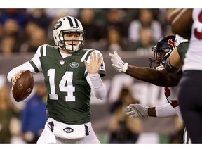 New York Jets quarterback Sam Darnold (14) tries to avoid a sack from Houston Texans nose tackle Brandon Dunn during the first half of an NFL football game, Saturday, Dec. 15, 2018, in East Rutherford, N.J.