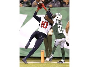 Houston Texans wide receiver DeAndre Hopkins (10) makes a touchdown catch on a pass from quarterback Deshaun Watson, not pictured, as New York Jets cornerback Morris Claiborne (21) defends during the second half of an NFL football game, Saturday, Dec. 15, 2018, in East Rutherford, N.J. The Texans won 29-22.