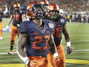 Syracuse running back Abdul Adams (23) celebrates after scoring a touchdown on a 1-yard run against West Virginia during the first half of the Camping World Bowl NCAA college football game Friday, Dec. 28, 2018, in Orlando, Fla.