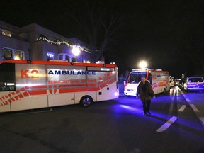 Ambulances stand outside a church in Vienna, Austria, Thursday, Dec. 27, 2018. First police reports indicated an armed robbery.