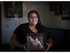 File - In this July 13, 2018, file photo, Kimberly Loring holds a photo of her sister, Ashley HeavyRunner Loring, who went missing on the Blackfeet Indian Reservation as she stands in her grandmother's home in Browning, Mont. Loring, the sister of a missing Blackfeet woman in Montana is expressing frustration over police's initial response to her loved one's disappearance, telling U.S. senators in prepared testimony Wednesday, Dec. 12, 2018, that "dysfunctional" investigations into missing persons cases have troubled numerous Native American families.