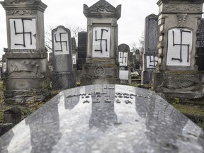 Jewish tombstones are desecrated with swastikas in the Herrlisheim Jewish cemetery, north of Strasbourg, eastern France, Thursday, Dec. 13, 2018.