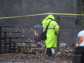 An investigator works the scene of a small plane crash in a city park which killed all on board, Thursday, Dec. 20, 2018, in northwest Atlanta.