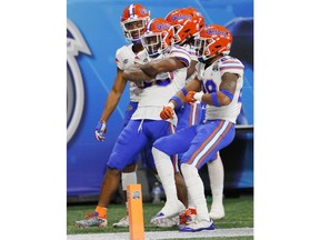 Florida players celebrate a run against Michigan during the first half of the Peach Bowl NCAA college football game, Saturday, Dec. 29, 2018, in Atlanta.