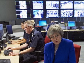 Prime Minister Theresa May speaks to UK Border Force officers during a visit to the UK Border Force Command Centre at Heathrow Airport's Terminal 5, Wednesday Dec. 19, 2018.  The British government on Wednesday published long-awaited plans for a post-Brexit immigration system that will end free movement of EU citizens to the U.K.