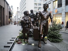 People pass a commemorative memorial statue to perpetuating the memory of the 'Kindertransport' (children transport) near Friedrichstrasse train station in central in Berlin, Germany, Monday, Dec. 17, 2018. Germany has agreed to one-time payments for survivors, primarily Jews, who were evacuated from Nazi Germany as children, many of whom never saw their parents again.