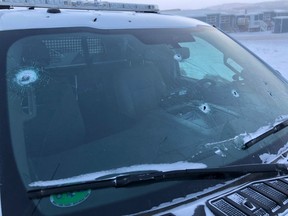 A Royal Canadian Mounted Police vehicle with bullet holes in the windshield is shown in this recent handout photo. Mounties in Nunavut have issued a "call for action" asking people to secure their guns after two recent standoffs, including one where a man opened fire on officers.