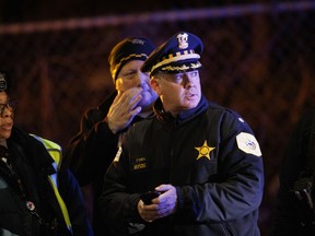Police officers work the scene where two officers were killed after they were struck by a South Shore train near 103rd Street and Dauphin Avenue on Monday, Dec. 17, 2018, in Chicago. Police spokesman Anthony Guglielmi posted on Twitter that the "devastating tragedy" occurred when the officers were investigating a shots-fired call.