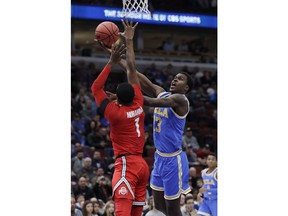 UCLA guard Kris Wilkes, right, drives to the basket against Ohio State guard Luther Muhammad during the first half of an NCAA college basketball game in the fifth annual CBS Sports Classic, Saturday, Dec. 22, 2018, in Chicago.