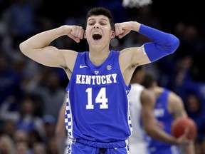 Kentucky's Tyler Herro reacts after forward Reid Travis scored against North Carolina during the first half of an NCAA college basketball game Saturday, Dec. 22, 2018, in Chicago.