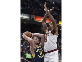 Indiana Pacers' Domantas Sabonis (11) is defended by Cleveland Cavaliers' Channing Frye (9) during the first half of an NBA basketball game, Tuesday, Dec. 18, 2018, in Indianapolis.