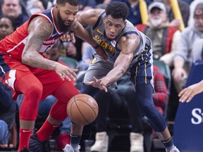 Washington Wizards forward Markieff Morris (5), left, and Indiana Pacers forward Thaddeus Young (21) battle for the ball during the second half of an NBA basketball game, Sunday, Dec. 23, 2018, in Indianapolis.