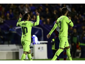 FC Barcelona's forward Lionel Messi, left, celebrate after scoring the 0-4 goal with his teammate FC Barcelona's defender Gerard Pique, right, during their La Liga soccer match between Levante UD and FC Barcelona at Ciutat de Valencia stadium in Valencia, Spain, Sunday, Dec. 16, 2018.