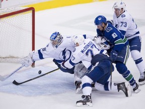 Tampa Bay Lightning goaltender Andrei Vasilevskiy (88) tries to stop Vancouver Canucks defenceman Christopher Tanev's goal as Tampa Bay Lightning defenceman Ryan McDonagh (27), Tampa Bay Lightning left wing Adam Erne (73) and Vancouver Canucks center Jay Beagle (83) look on during third period NHL action at Rogers Arena in Vancouver, Tuesday, Dec. 18, 2018.