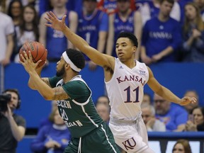 Kansas' Devon Dotson (11) pressures Eastern Michigan's Malik Ellison (10) during the first half of an NCAA college basketball game Saturday, Dec. 29, 2018, in Lawrence, Kan.