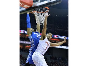 Kentucky forward PJ Washington (25) goes in for a dunk over the defense of Louisville guard Christen Cunningham (1) during the first half of an NCAA college basketball game in Louisville, Ky., Saturday, Dec. 29, 2018.