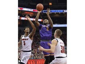 Lipscomb center Ahsan Asadullah (2) attempts a shot between the defense of Louisville center Malik Williams (5) and guard Ryan McMahon (30) during the first half of an NCAA college basketball game in Louisville, Ky., Wednesday, Dec. 12, 2018.