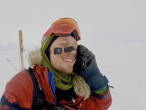 In this photo provided by Colin O'Brady, of Portland., Ore., he speaks on the phone in Antarctica on Wednesday, Dec. 26, 2018. He has become the first person to traverse Antarctica alone without any assistance. O'Brady finished the 932-mile (1,500-kilometer) journey across the continent in 54 days, lugging his supplies on a sled as he skied in bone-chilling temperatures.