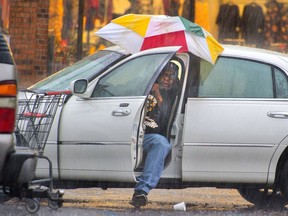 Harry Anderson tries to stay relatively dry as he maneuvers his umbrella into position before slipping out of his car during a steady rainstorm, Thursday, Dec 27, 2018, in Baton Rouge, La. He was preparing to go inside Shoppers Value on Plank Road near J.H. Cooney Street to buy some groceries, and he succeeded in staying dry, for the most part, he said.