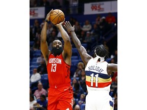 Houston Rockets guard James Harden (13)  shoots over New Orleans Pelicans guard Jrue Holiday (11) during the first half of an NBA basketball game, Saturday, Dec. 29, 2018, in New Orleans.