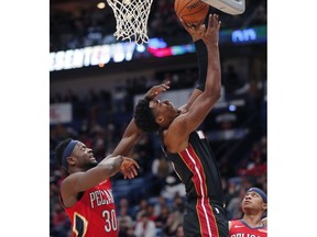 Miami Heat center Hassan Whiteside (21) goes to the basket against New Orleans Pelicans forward Julius Randle (30) in the first half of an NBA basketball game in New Orleans, Sunday, Dec. 16, 2018.