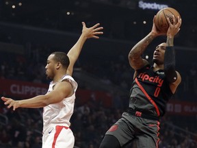 Portland Trail Blazers' Damian Lillard (0) shoots over Los Angeles Clippers' Avery Bradley during the first half of an NBA basketball game Monday, Dec. 17, 2018, in Los Angeles.