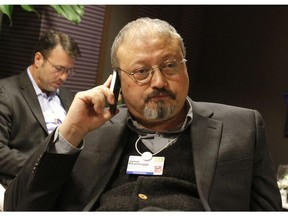 In this Jan. 29, 2011, file photo, Saudi Arabian journalist Jamal Khashoggi speaks on his cellphone at the World Economic Forum in Davos, Switzerland.