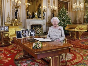 In this image released on Tuesday, Dec. 25, 2018, Britain's Queen Elizabeth poses for a photograph after she recorded her annual Christmas Day message, in the White Drawing Room of Buckingham Palace, London.