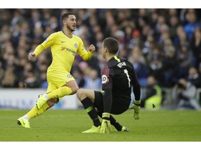 Chelsea's Eden Hazard, left, scores past Brighton goalkeeper Mathew Ryan his side's second goal during the English Premier League soccer match between Brighton and Hove Albion and Chelsea at the Amex Stadium in Brighton, England, Sunday, Dec. 16, 2018.