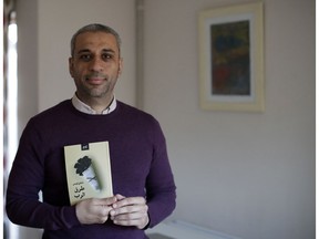 In this Tuesday, Dec. 4, 2018 photo, journalist and author Shady Lewis Botros poses with a copy of his book, "Ways of the Lord," in London. The new Arabic-language novel, the author's first, explores the lives of Egyptian Christians, dealing with discrimination but also a Church aligned with a state seeking to control them.