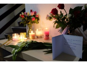 Tributes are placed on a table in an apartment block in Rotterdam, Netherlands, on Friday Dec. 14, 2018, where American student Sarah Papenheim lived. Papenheim, a 21-year-old psychology student at Erasmus University, was fatally stabbed at her home on Wednesday. Police say a 23-year-old man has been arrested on suspicion of involvement in her death.