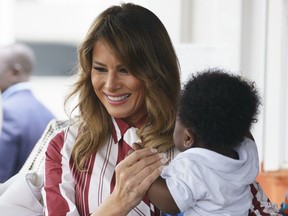 Year End Africa 2018 - YEAR IN REVIEW.  FILE - In this Tuesday Oct. 2, 208 file photo, U.S. first lady Melania Trump holds a baby as she visits Greater Accra Regional Hospital in Accra, Ghana. With Trump showing little interest in Africa, first lady Melania announced that the continent would be her first extended solo visit. Holding babies, feeding elephants and wearing a much-noticed pith helmet, she made few waves as some residents of Ghana, Malawi and Kenya admitted they had never heard of her.