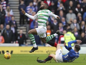 Celtic's Olivier Ntcham, left, and Rangers' Andrew Halliday clash during their Scottish Premiership soccer match at Ibrox Stadium in Glasgow, Scotland, Saturday Dec. 29, 2018.