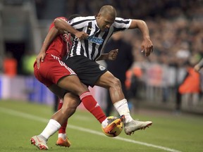 Fulham's Denis Odoi, left, and Newcastle United's Salomon Rondon battle for the ball during the English Premier League soccer match between Newcastle United and Fulham at St James' Park, Newcastle, England. Saturday, Dec. 22, 2018.