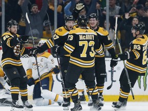 Boston Bruins' Patrice Bergeron (37) celebrates his goal with teammates Matt Grzelcyk (48), Charlie McAvoy (73), Brad Marchand (63) and Danton Heinen (43) during the first period of an NHL hockey game against the Nashville Predators in Boston, Saturday, Dec. 22, 2018.