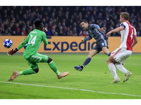 Bayern's Robert Lewandowski, center, scores his side's opening goal during the Champions League group E soccer match between Ajax and FC Bayern Munich at the Johan Cruyff Arena in Amsterdam, Netherlands, Wednesday, Dec. 12, 2018.