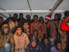 Migrants gather on the deck of the Spanish NGO Proactiva Open Arms rescue vessel after being rescued in the central Mediterranean sea Dec. 21, 2018, before disembarking in the port of Crinavis in Algeciras, Spain, Friday, Dec. 28, 2018. Other European countries such as Italy, Malta or Greece closed their ports to the ship and only Spain admitted its entry. To reach Crinavis they have sailed for 6 days with more than 300 migrants on board.