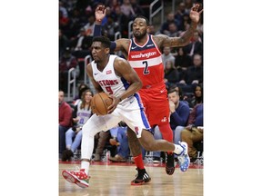 Detroit Pistons guard Langston Galloway (9) drives to the basket past Washington Wizards guard John Wall (2) during the first half of an NBA basketball game Wednesday, Dec. 26, 2018, in Detroit.