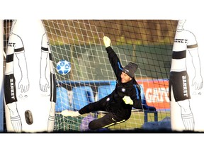 Inter Milan goalkeeper Samir Handanovic dives during a training session ahead of Tuesday's Champions League, group B soccer match against PSV Eindhoven, at the Inter Milan training center in Appiano Gentile, Italy, Monday, Dec. 10, 2018.