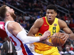 Milwaukee Bucks forward Giannis Antetokounmpo (34) charges into Detroit Pistons forward Blake Griffin (23) in the first half of an NBA basketball game in Detroit, Monday, Dec. 17, 2018.